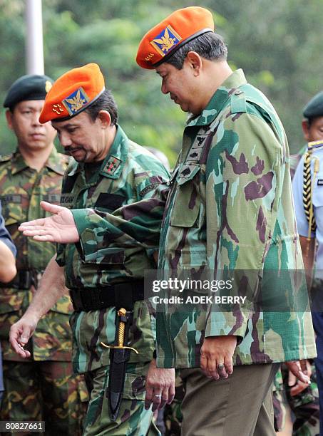 Sultan of Brunei Hassanal Bolkiah and Indonesian President Susilo Bambang Yudhoyono arrive in full Indonesian Air Force uniforms to attend a ceremony...