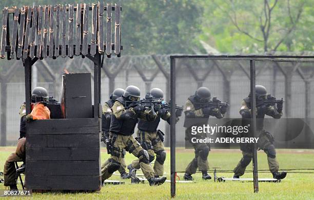 Indonesian Air Force special unit Bravo soldiers approach to rescue a "hostages" during a drill witnessed by the Sultan of Brunei Hassanal Bolkiah...
