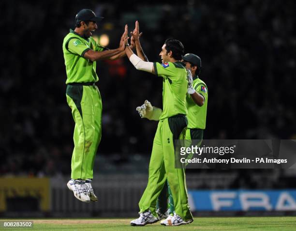 Pakistan's Wahaab Riaz is congratulated by bowler Umar Gul after catching England's Eoin Morgan on 61 during the Third One Day International at the...