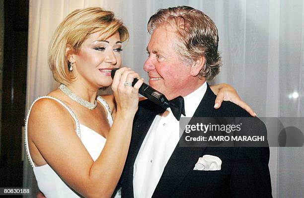 Egyptian actor Hussein Fahmi looks at his bride Egyptian actress Liqa Sweidan as she sings during their wedding ceremony in Cairo, 29 December 2007....