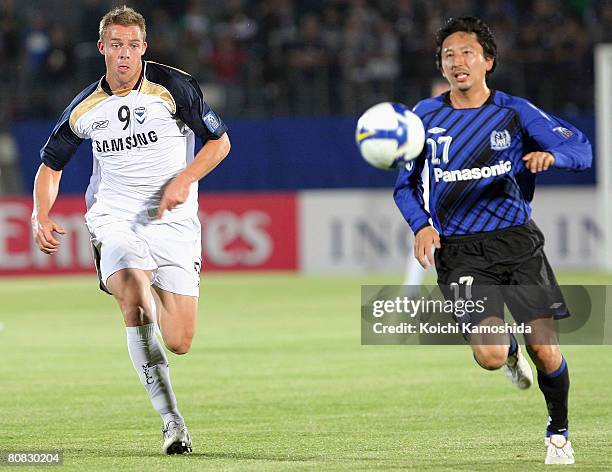 Daniel Allsopp of Melbourne Victory and Hideo Hashimoto of Gamba Osaka compete for the ball during the AFC Champions League Group G match between...