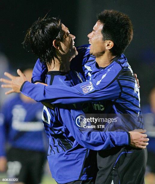 Japan's Gamba Osaka players Masato Yamazaki and Tomokazu Myojin celebrate after Yamazaki scored a goal during the first half of the Asian Champions...