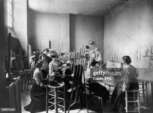 Group of young women artists sketching a nude male life model, circa 1910.