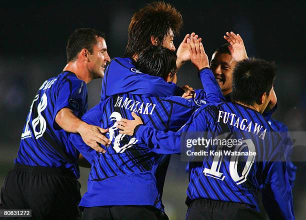 Masato Yamazaki, Takahiro Futagawa and Volnei Jader Spindler of Gamba Osaka celebrate Gamba Osaka's first goal during the AFC Champions League Group...