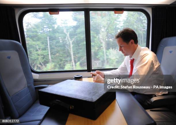 Deputy Prime Minister Nick Clegg works on the 17.00 Acela Express train from Washington DC to New York City after having lunch with US Vice President...