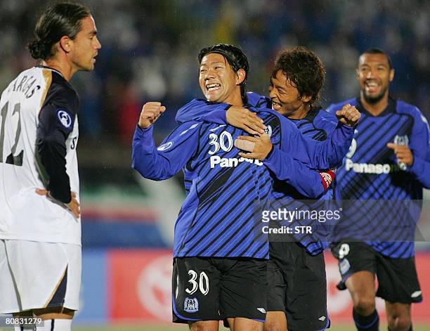 Japan's Gamba Osaka players Masato Yamazaki celebrate with teammates after scoring the second goal during the second half of the Asian Champions...