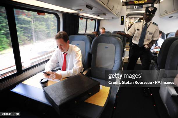 Deputy Prime Minister Nick Clegg works on the 17.00 Acela Express train from Washington DC to New York City after having lunch with US Vice President...