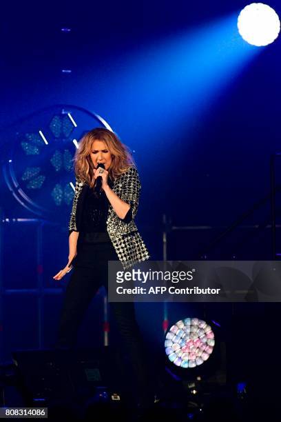 Canadian singer Celine Dion performs on the stage of the AccorHotels Arena in Paris on July 4, 2017. / AFP PHOTO / Martin BUREAU