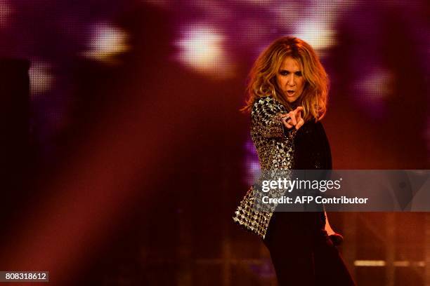 Canadian singer Celine Dion performs on the stage of the AccorHotels Arena in Paris on July 4, 2017. / AFP PHOTO / Martin BUREAU