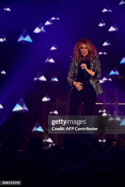 Canadian singer Celine Dion performs on the stage of the AccorHotels Arena in Paris on July 4, 2017. / AFP PHOTO / Martin BUREAU