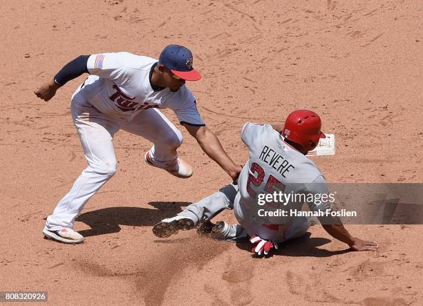 Eduardo Escobar of the Minnesota Twins catches Ben Revere of the Los Angeles Angels of Anaheim stealing second base during the fifth inning of the...