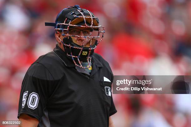 Home plate umpire Paul Emmel wears a patriotic mask to honor Independence Day in a game between the St. Louis Cardinals and the Miami Marlins at...