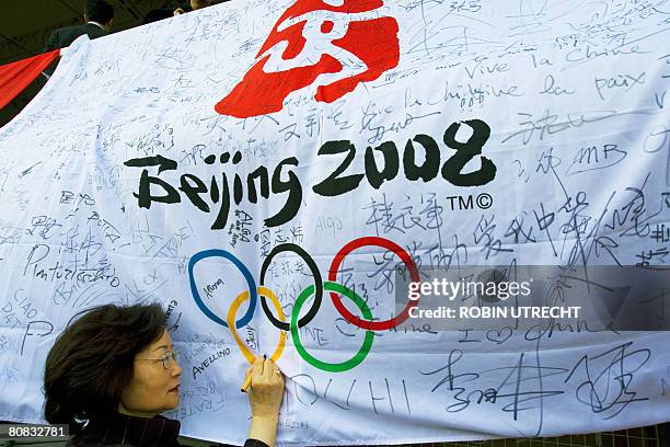 Chinese woman writes her autograph to support the Olympics 2008 in the Olympic stadium in Amsterdam, on April 23, 2008. A group of Chinese supporters...