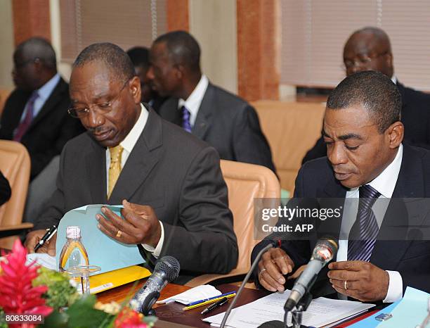 Governer of the West African States Central Bank , Philippe Dacoury Tabley sits with Ivorian Minister of the Economy and Finance Charles Diby Koffi...