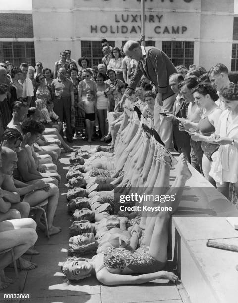 Beauty contestants are judged solely on their figures, thanks to the introduction of papier mache masks, at the Butlins Holiday Camp in...