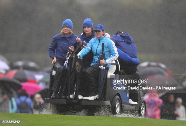 Ian Poulter's wife Katie Poulter and Ross Fisher's wife Jo Fisher take a ride on a golf buggy during the friday fourball round