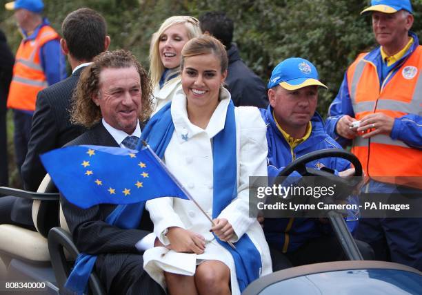 Europe's Miguel Angel Jimenez wife his wife Marian are driven away from the Opening Ceremony