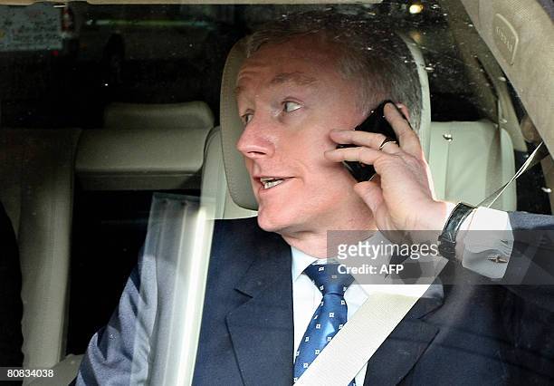 Sir Fred Goodwin, Chief-Executive Officer of the Royal Bank of Scotland, speaks on his mobile phone as he leaves the Edinburgh International...