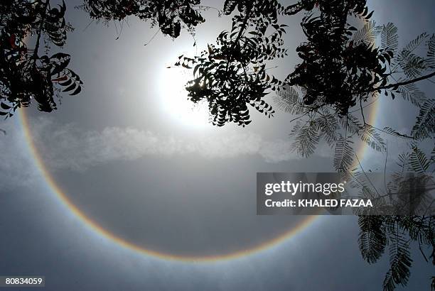 Solar halo is seen around the sun in the Yemeni port city of Aden on April 22, 2008. The optical phenomenon is mostly caused by ice crystals in cold...