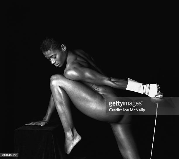 Three-time olympic fencer, Sharon Monplaisir, poses with her saber in June of 1996 at a training facility in Atlanta, Georgia. The olympians of...