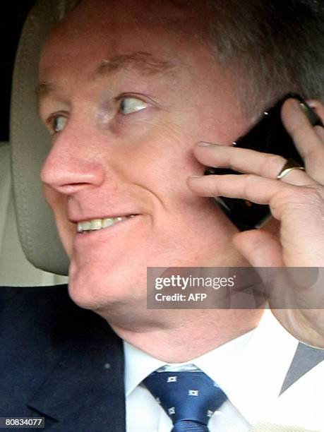 Sir Fred Goodwin, Chief-Executive Officer of the Royal Bank of Scotland, speaks on his mobile phone as he leaves the Edinburgh International...