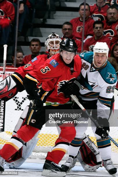 Dion Phaneuf of the Calgary Flames jostles for position in front of the net against Ryan Clowe of the San Jose Sharks during game six of the 2008 NHL...