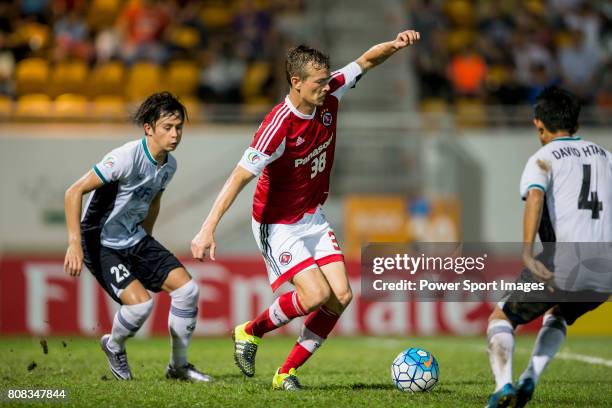 Yangon United defender Pyaye Phyo Aung, South China forward Ryan Griffiths, and Yangon United midfielder David Htan compete for the ball during the...