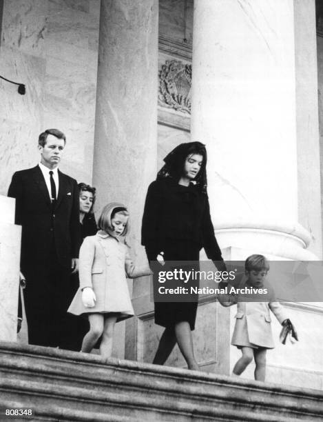 Jackie Kennedy leaves the U.S. Capitol Building with her children John and Caroline after attending a ceremony for her late husband John F. Kennedy...