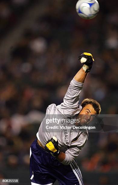 Goalkeeper Steve Cronin of the Los Angeles Galaxy punches the ball away for a save in the first half against the Houston Dynamo during their MLS game...