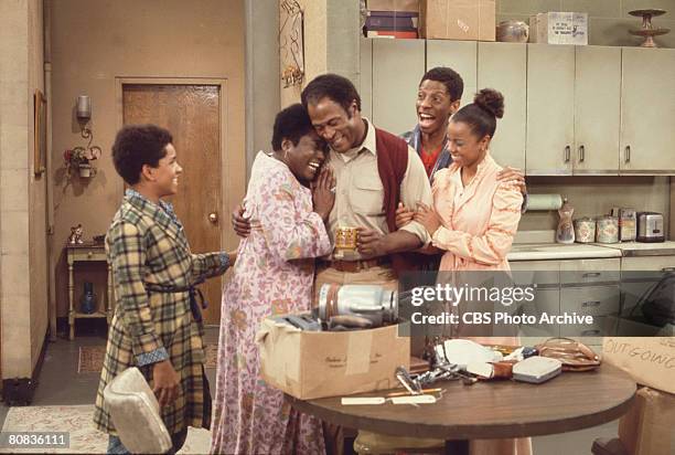 From left, American actors Ralph Carter, Esther Rolle , John Amos, Jimmie Walker, and BernNadette Stanis gather in the kitchen in a scene from the...