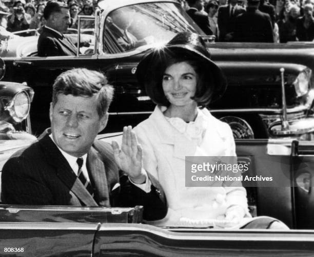 The President and Mrs. Kennedy ride in a parade March 27, 1963 in Washington.