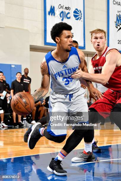 Michael Gbinije of the Detroit Pistons drives to the basket during the game against the Miami Heat during the 2017 Orlando Summer League on July 4,...