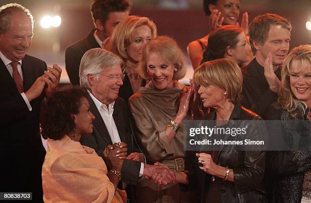 German actor Karlheinz Boehm is congratulated by Friedrich von Thun, his wife Almaz, Alice and Ellen Kessler, Uschi Glas, Yvonne Catterfeld,...