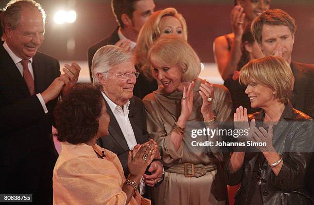 German actor Karlheinz Boehm is congratulated by Friedrich von Thun, his wife Almaz, Alice and Ellen Kessler, Uschi Glas and Joerg Pilawa after the...