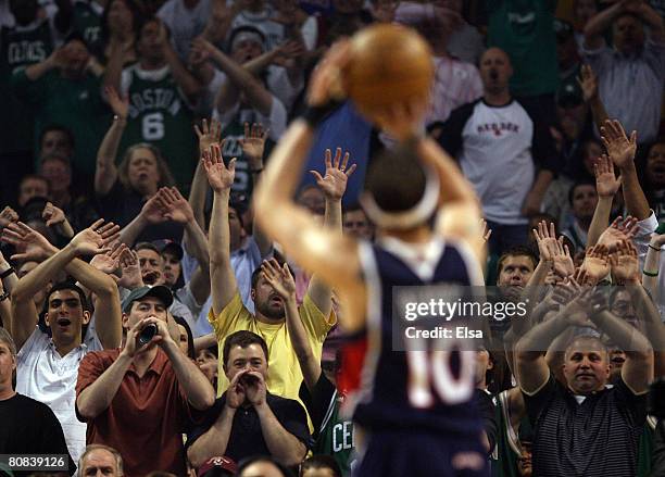 Mike Bibby of the Atlanta Hawks tries to shoot a free throw as the fans try to distract him in the first quarter against the Boston Celtics during...