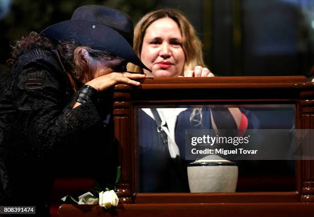 Ximena and Maria Jose daughters of Jose Luis Cuevas stand guard during an homage to Mexican artist Jose Luis Cuevas at Bellas Artes Palace on July...