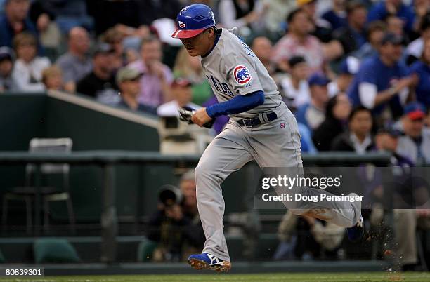 Kosuke Fukudome of the Chicago Cubs heads home to score the first run of the game on a sac fly by Mark De Rosa in the second inning against the...