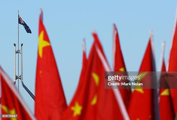 Chinese supporters hold flags at the start of the Olympic Torch relay at Reconciliation Place on April 24, 2008 in Canberra, Australia. The relay...