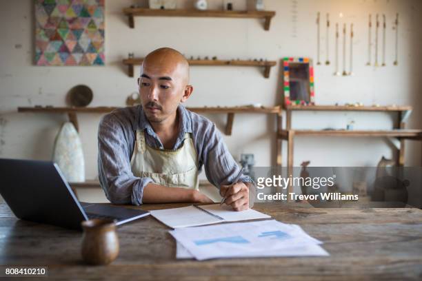 Shopkeeper doing his monthly financial planning and bookkeeping