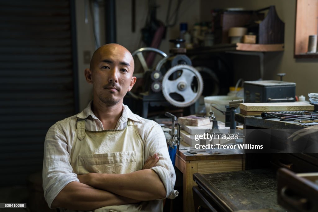 Portrait of a jewellery artist in his metal working workshop