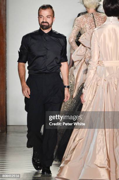 Julien Fournie acknowledges the audience after the Julien Fournie Haute Couture Fall/Winter 2017-2018 show as part of Haute Couture Paris Fashion...