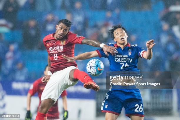 Guangzhou Midfielder Paulinho Maciel fights for the ball with Suwon Midfielder Yeom Ki Hun during the AFC Champions League 2017 Group G match Between...