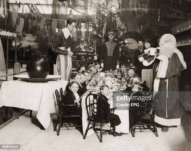 Bertram Mills provides a Christmas banquet for a group of circus performers at Olympia, circa 1930.