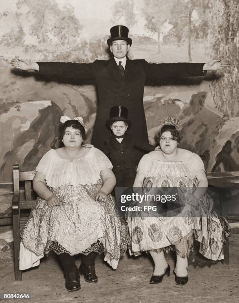 Circus performers Captain Gulliver and Major Mite pose with Annie and Lulu, who weigh 27 and 25 stone respectively, 1930. Major Mite was born...