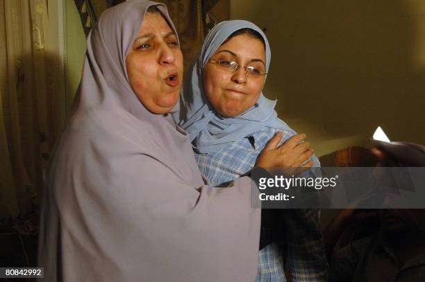 Egyptian Esra Abdel Fattah is hugged by her mother at her home in Cairo on April 23 after she was freed following a month's detention for forming a...