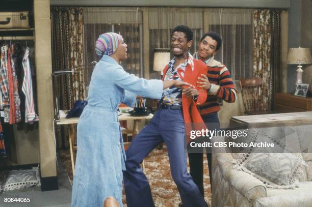 American actor Ralph Carter restrains Jimmie Walker, with help from actress Ja'net DuBois in a scene from the television show 'Good Times,' Los...