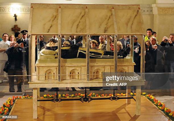 Pilgrims venerate the body of Padre Pio in a part-glass coffin in the crypt of the old Church of St. Mary of Grace at San Giovanni Rotondo in the...