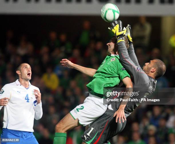 Northern Ireland's Gareth McAuley jumps with Italy goalkeeper Emiliano Viviano during the European Championship Qualifier, Group C match at the...