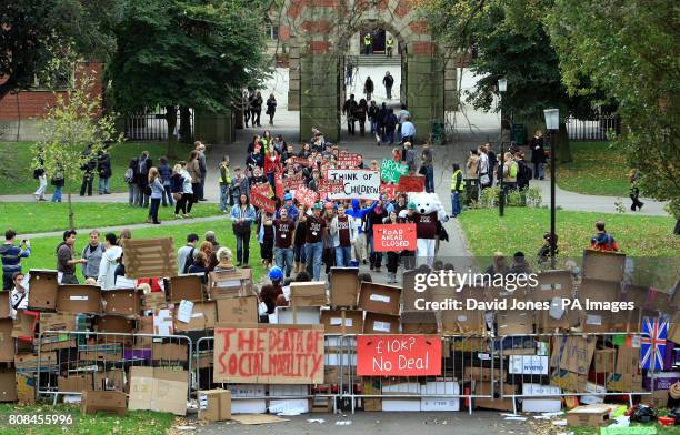 Students at the University of Birmingham march to a barrier constructed on campus to symbolize the barrier that the Browne report poses to higher...