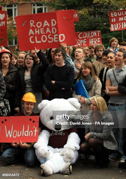 Students at the University of Birmingham march to a barrier constructed on campus to symbolize the barrier that the Browne report poses to higher...